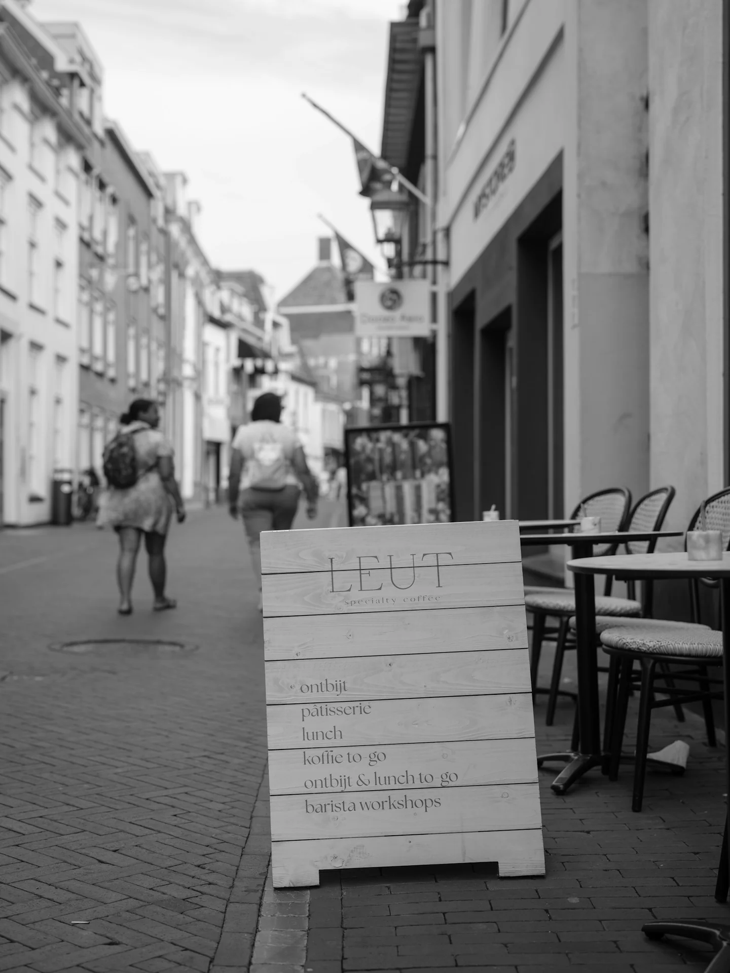 A neighborhood café terrace beside a pedestrian street
