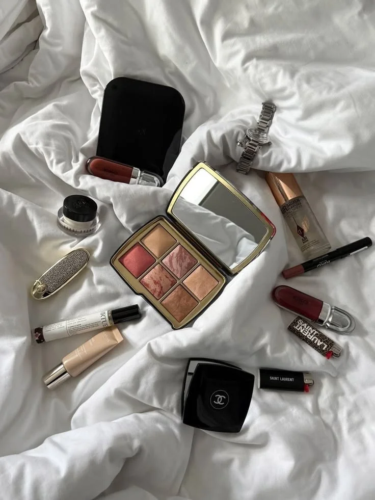 Makeup palette and lipstick on linen