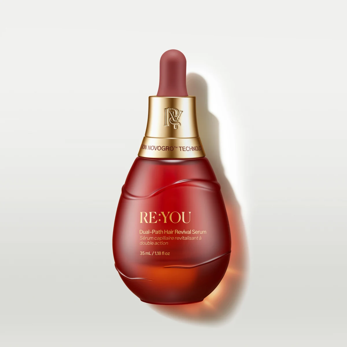 RE:YOU Dual-Path Hair Revival Serum bottle on a clean light background